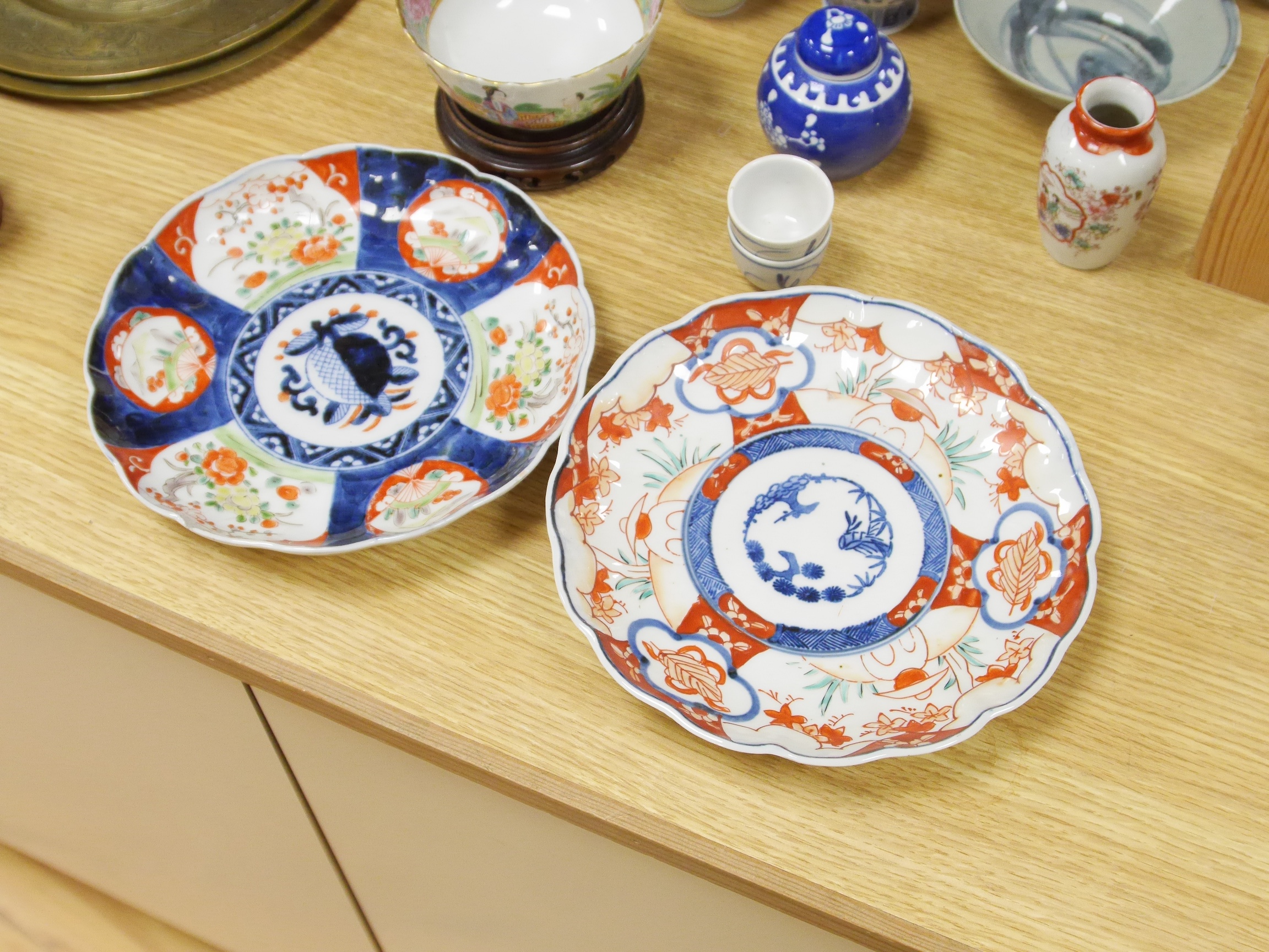 A large quantity of Chinese and Japanese ceramics and metalware to include Imari plates, blue and white vases and brass dishes, largest 37cm high. Condition - mostly fair to good